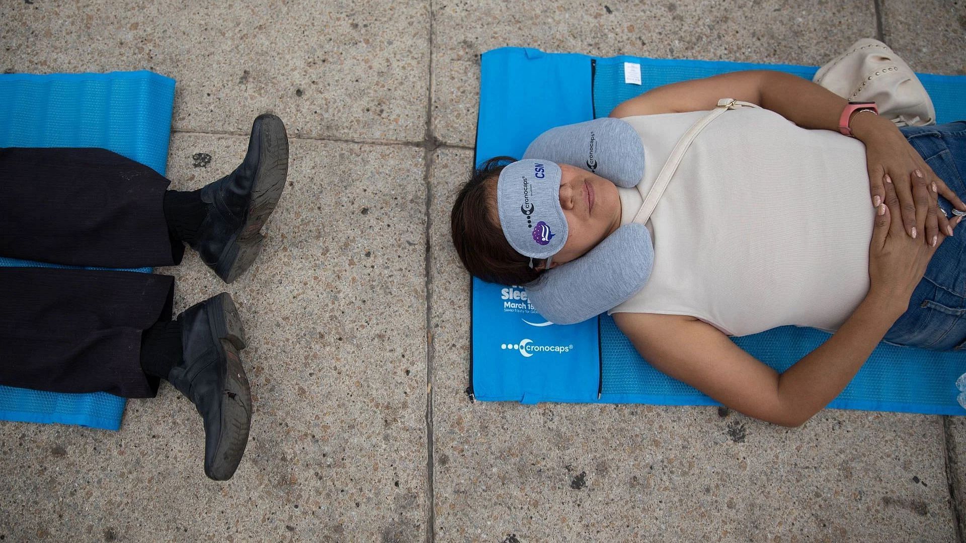People take part in the first mass nap to mark World Sleep Day (Image via Getty)